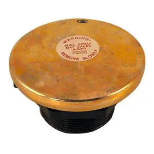 A gold colored lid with the words " caution " written on it.