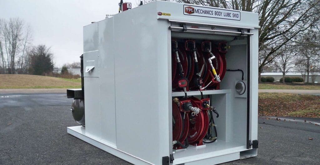 A large white box with many red hoses attached to it.
