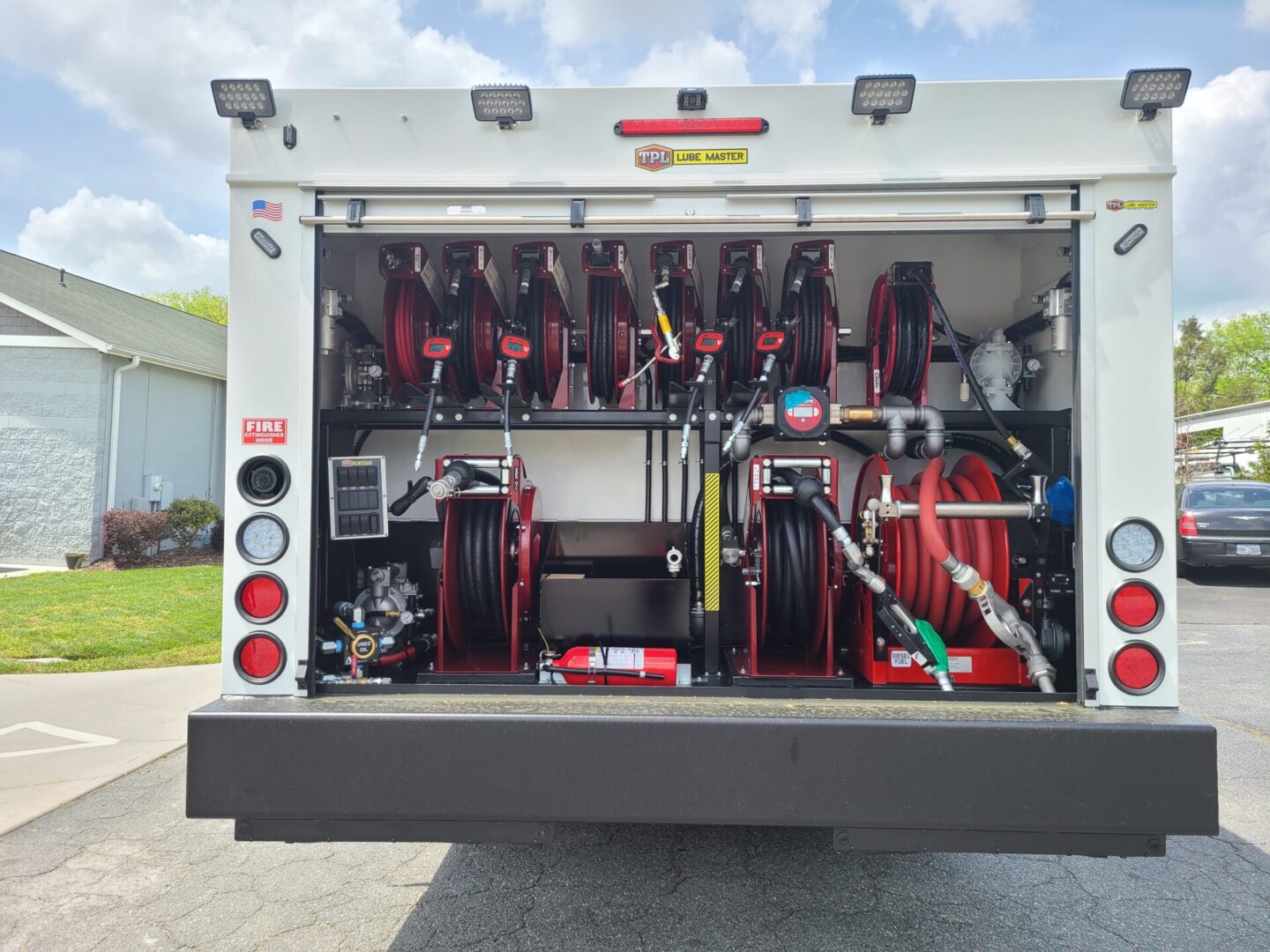 A fire truck with its doors open and the back of it.
