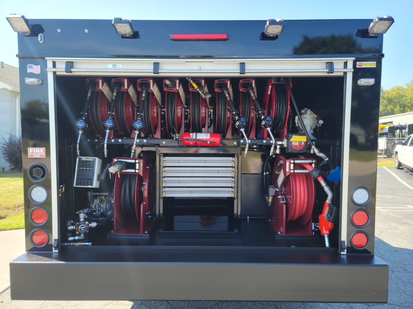 A fire truck with multiple hose racks and tools.