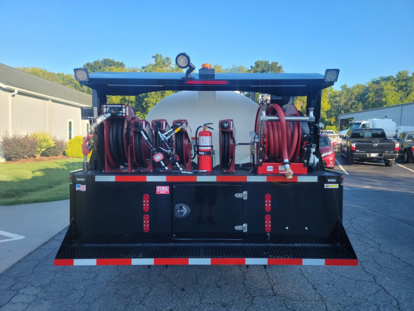 A truck with hoses and other equipment in the back.