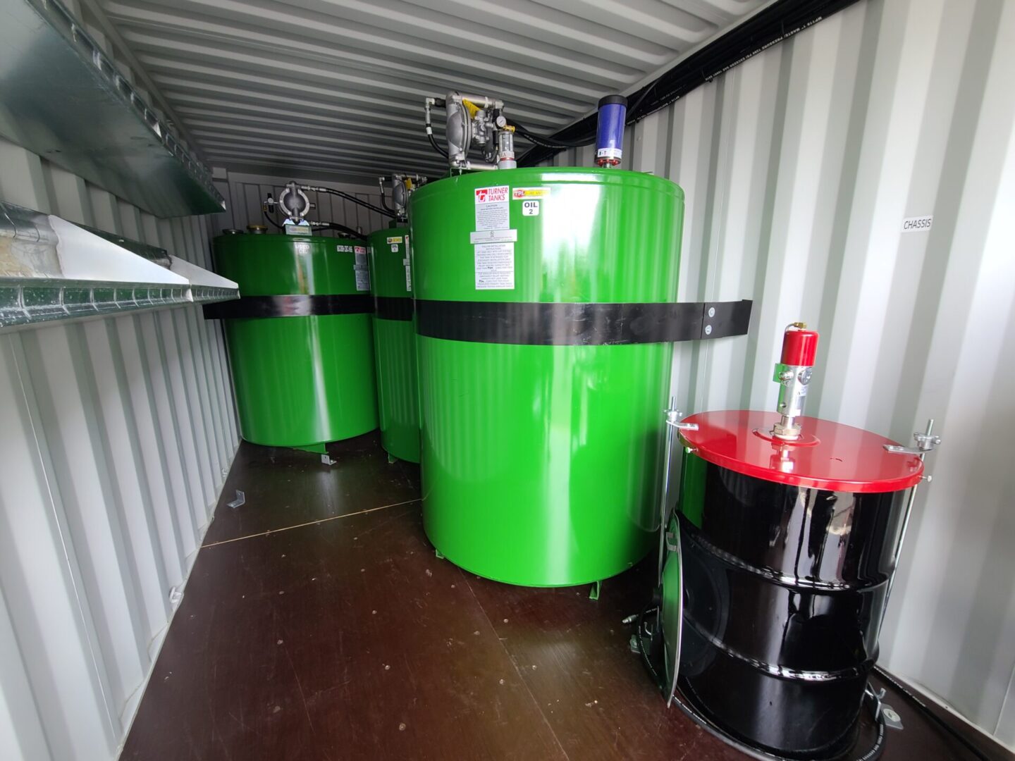 A group of green tanks sitting in a container.