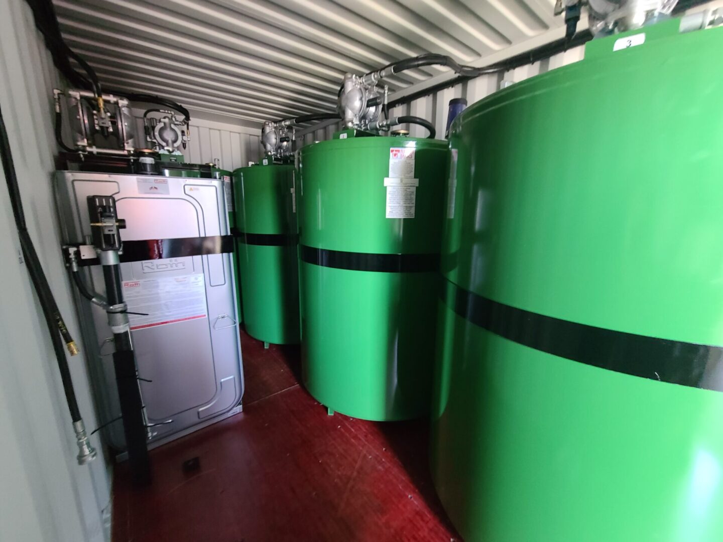 A group of green tanks sitting in a room.