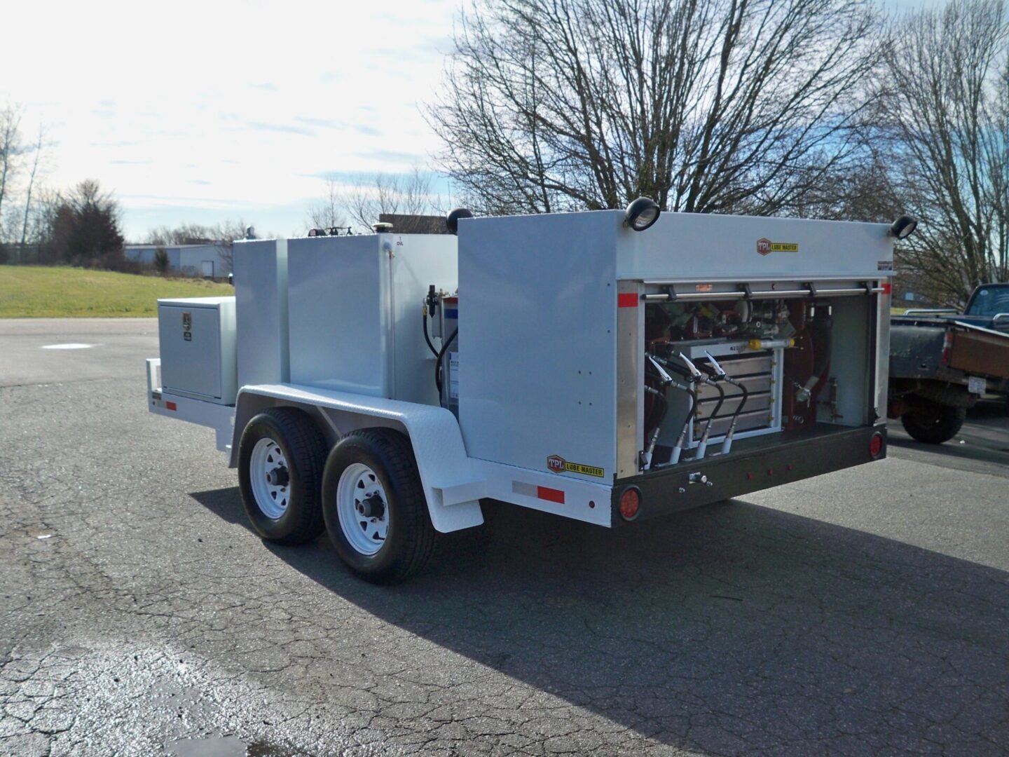 A white trailer with an open door on the side.
