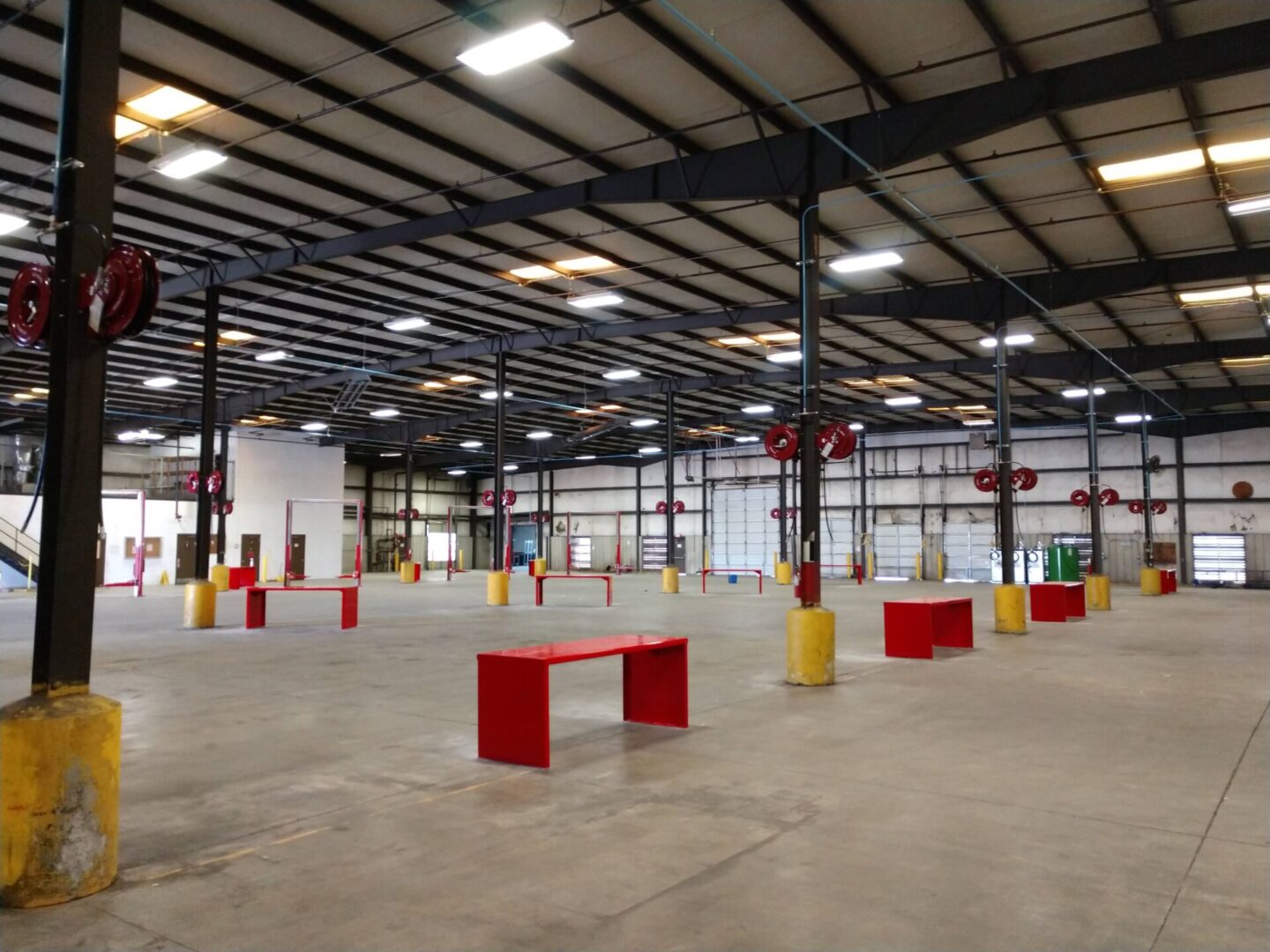 A large warehouse with many red and yellow benches.
