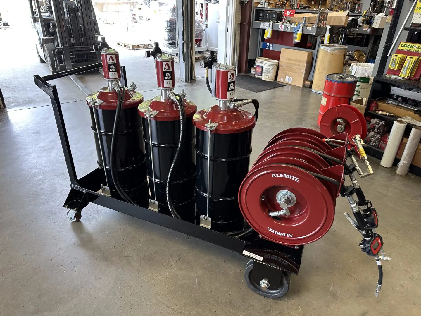 A cart with multiple drums and red valves.