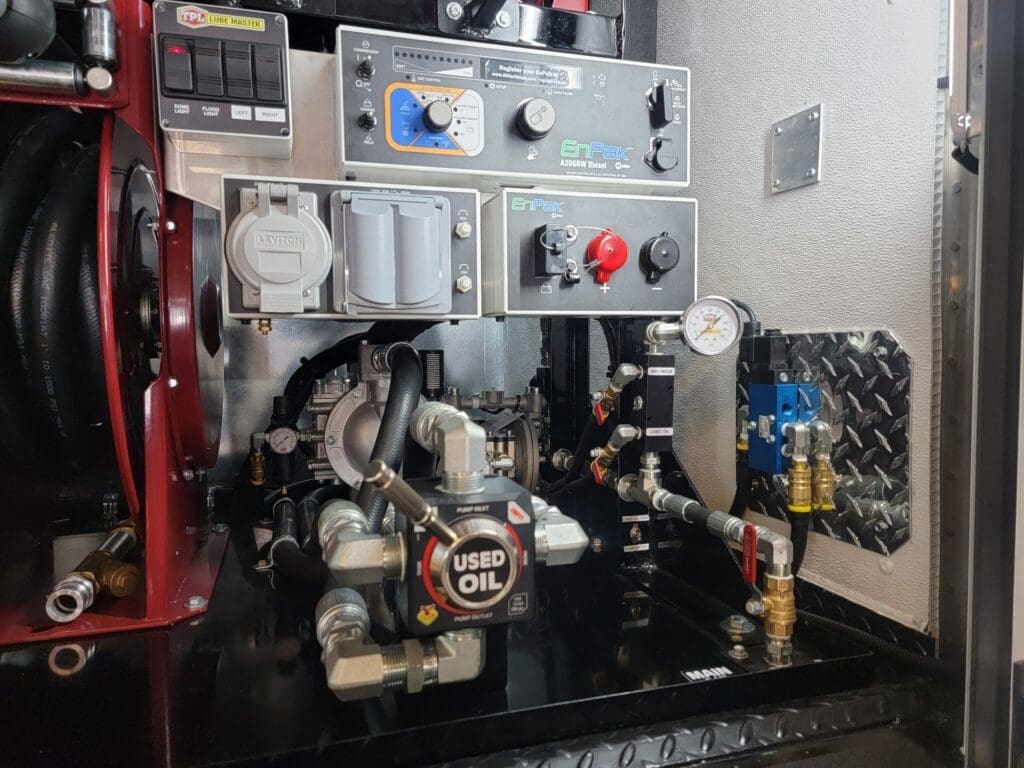 Taylor Pump & Lift air and lube system control panel showing EnPak gauges, pressure regulators, used oil pump, and hose reels for fleet maintenance operations.