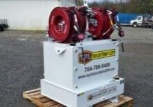 A white box with red hoses on top of it.