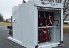 A large white box with many red hoses attached to it.