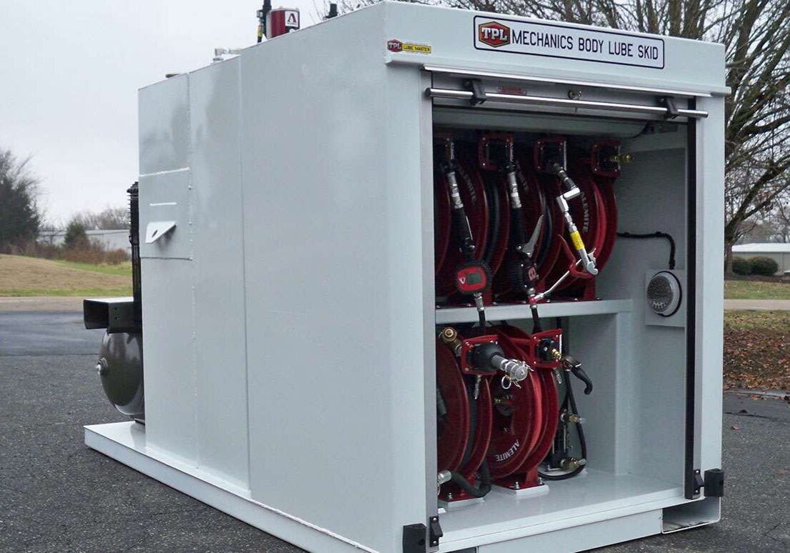 A large white box with many red hoses attached to it.
