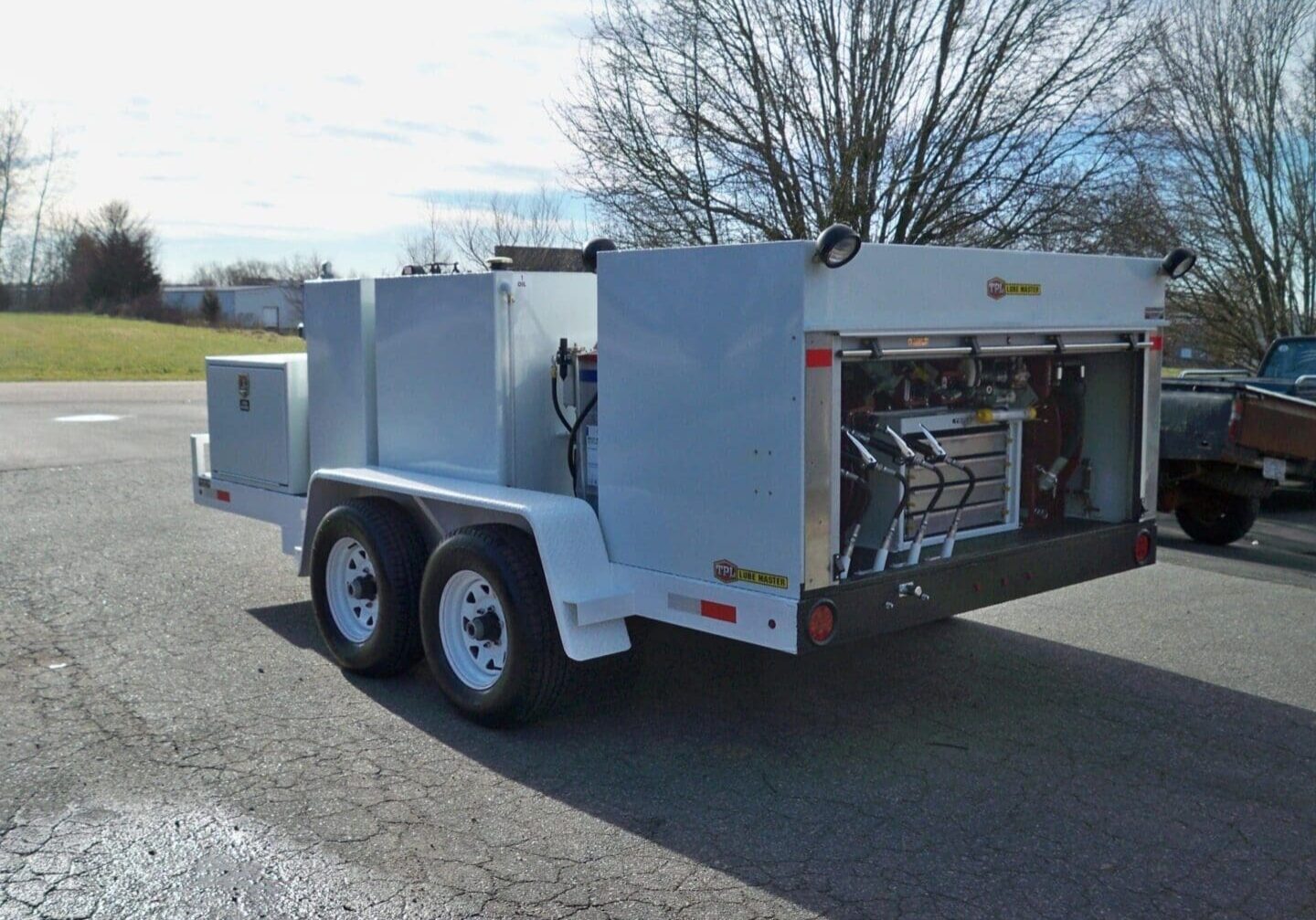 A white trailer with an open door on the side.